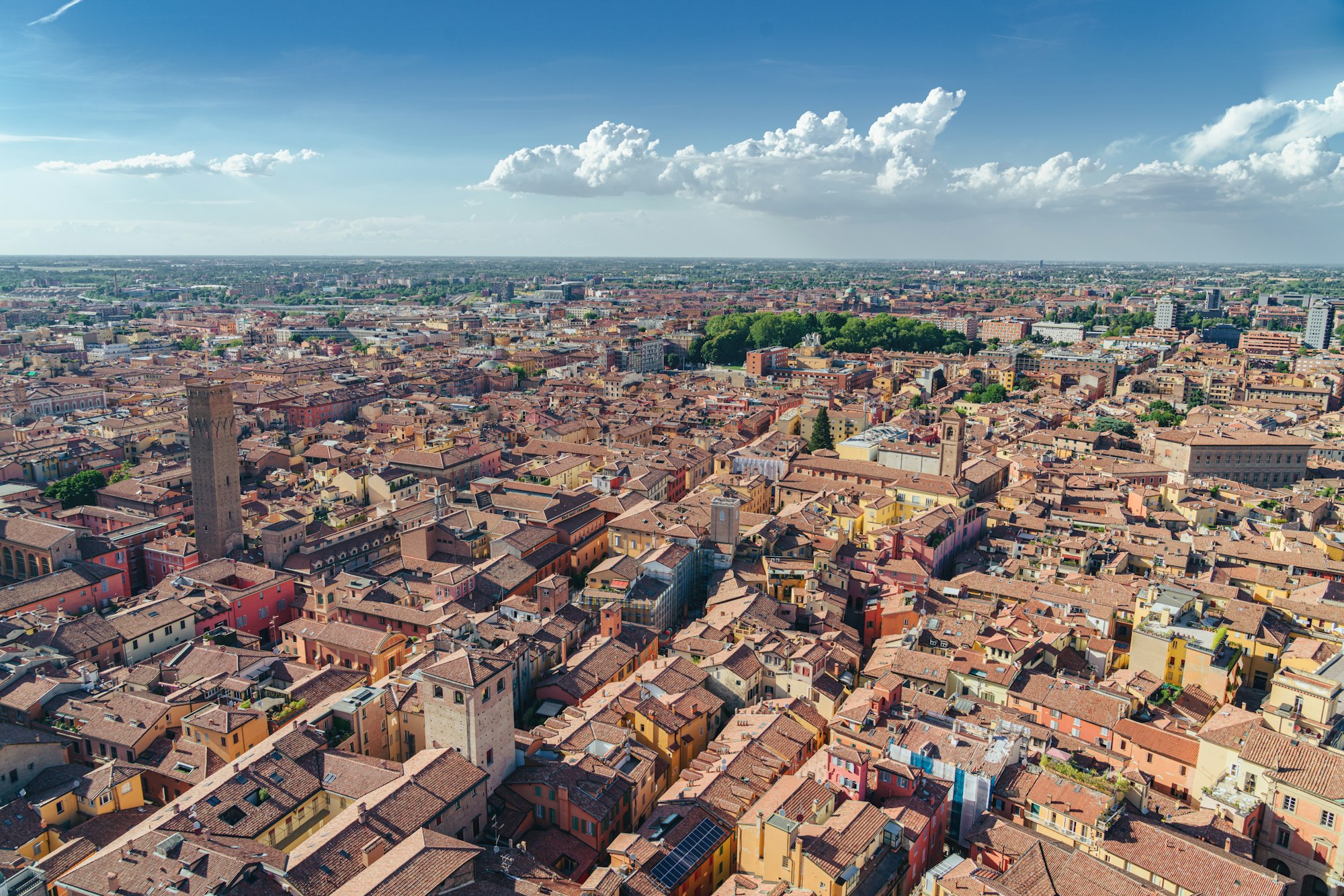 Aerial view of Bologna's rooftops and towers on a summer day