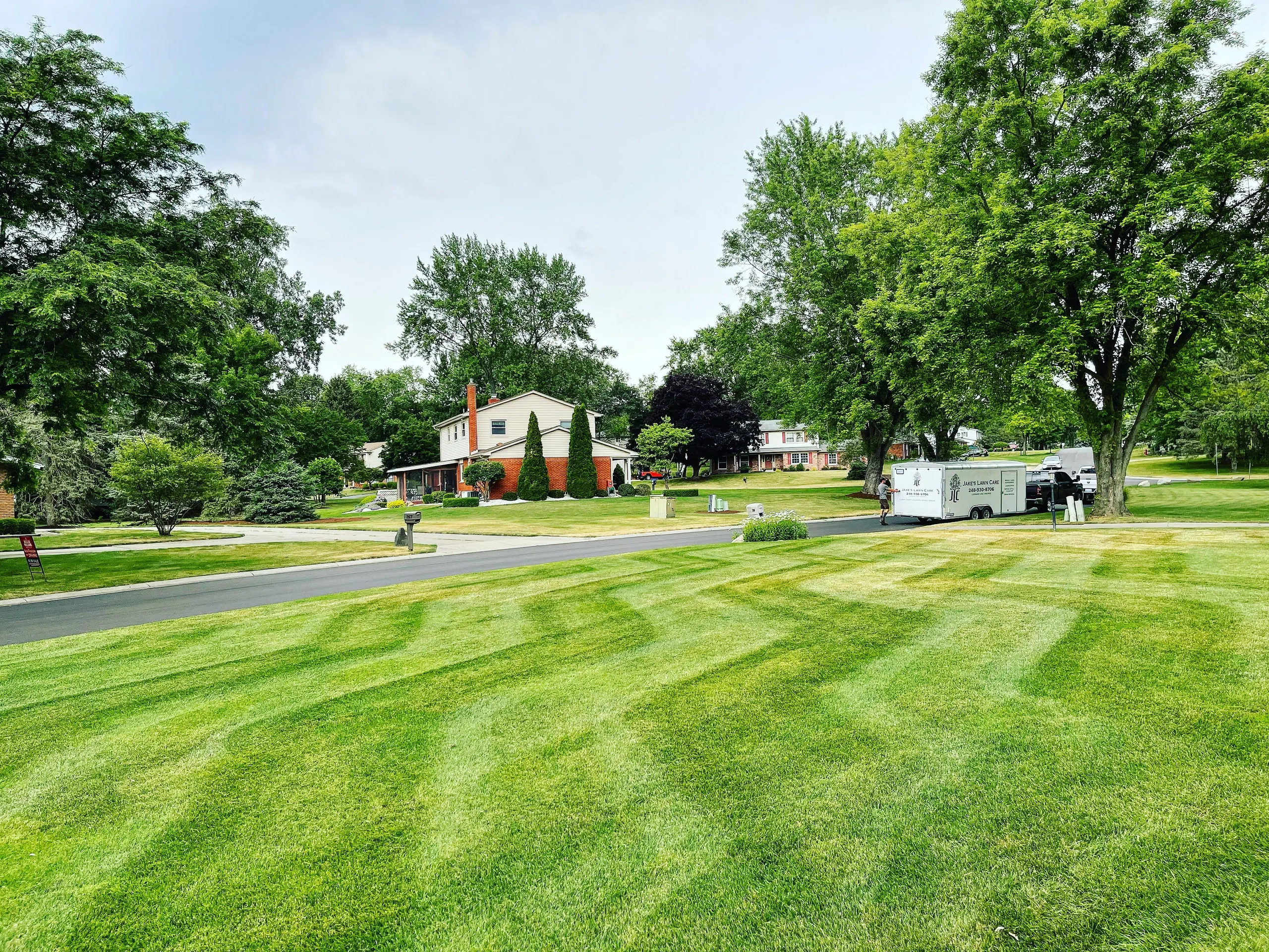 A beautiful green lawn with professional stripes from Jake's Lawn Care.