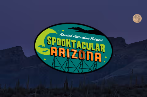 Spooktacular Overlay - Full moon rising over a silhouetted desert mountain range at dusk, with saguaro cacti dotting the foreground under a deep purple sky.