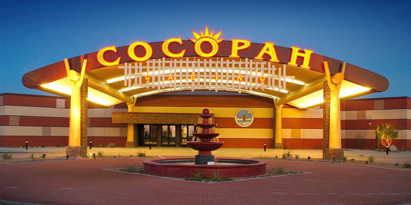 The entrance of the Cocopah Casino at dusk. Beautifully lit up with a large Cocopah sign on the marquee over the walkway 