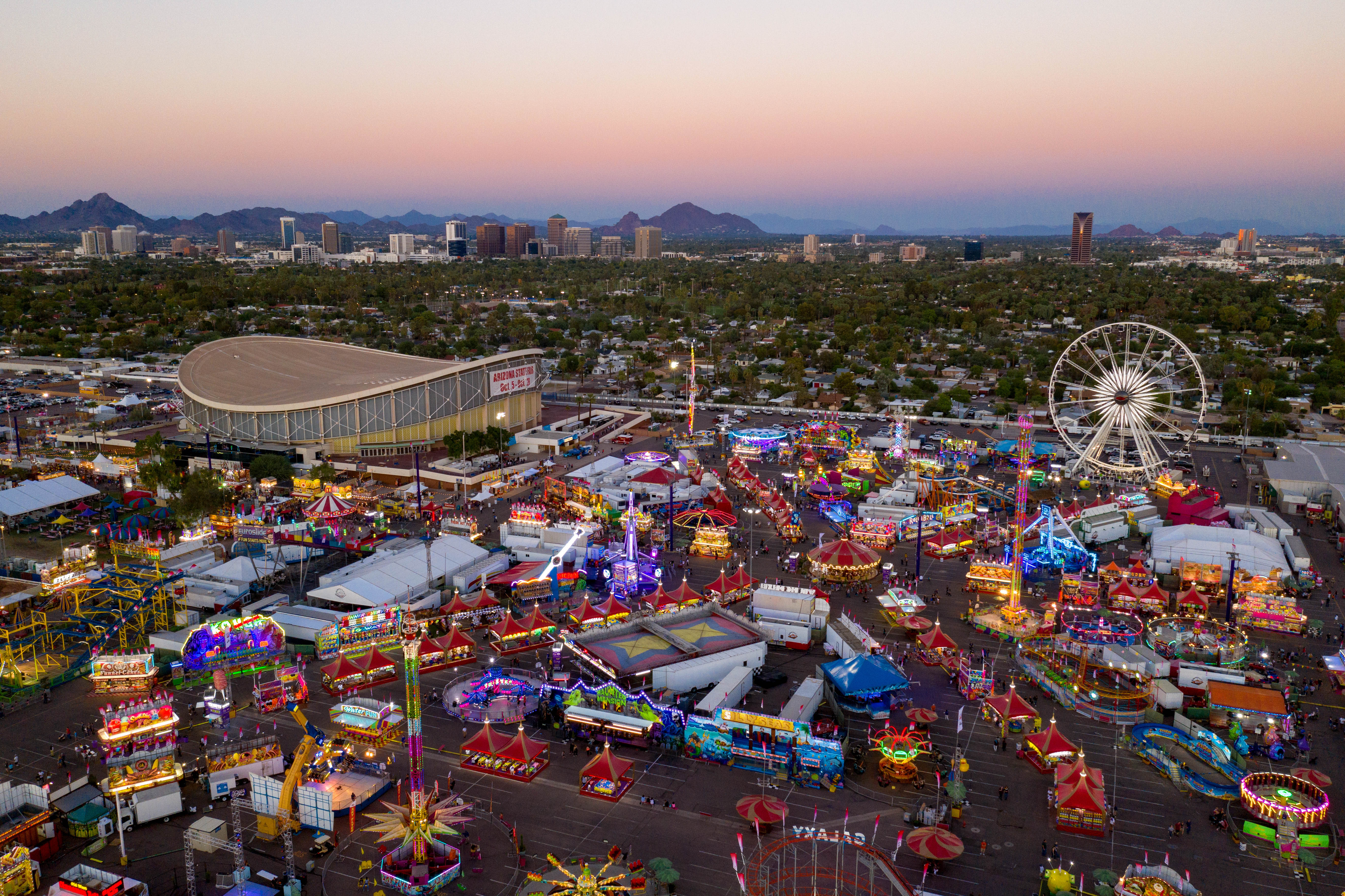 An overhead view of the Arizona State Fair with the Phoenix skyline in the background