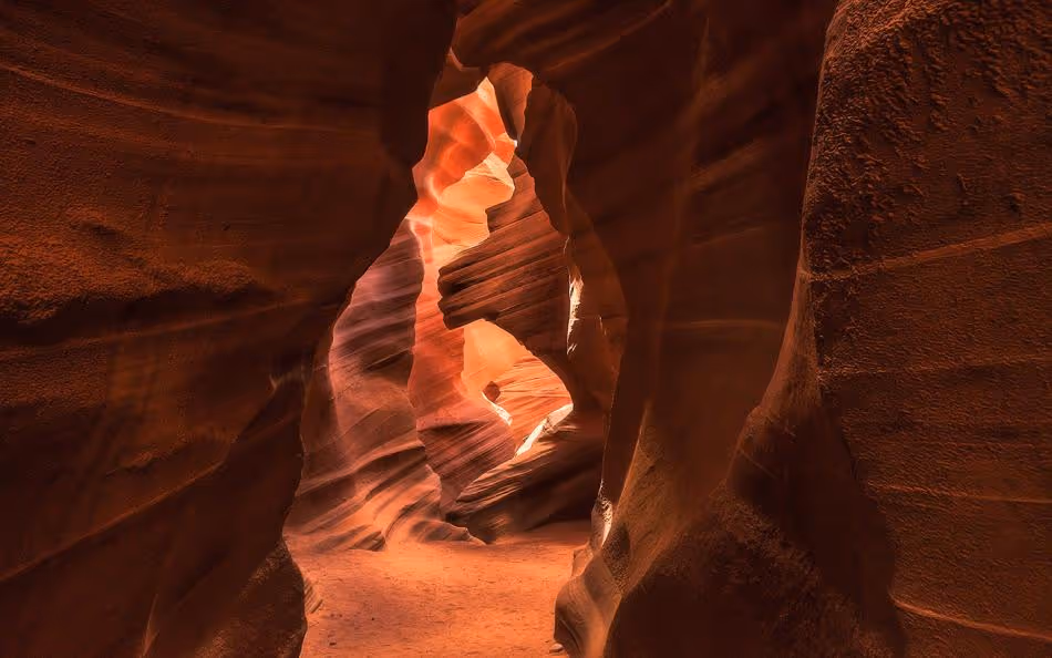 The reddish walls of Antelope Canyon swirl around each other, lit by sunlight. Credit: Brandon Erdman.