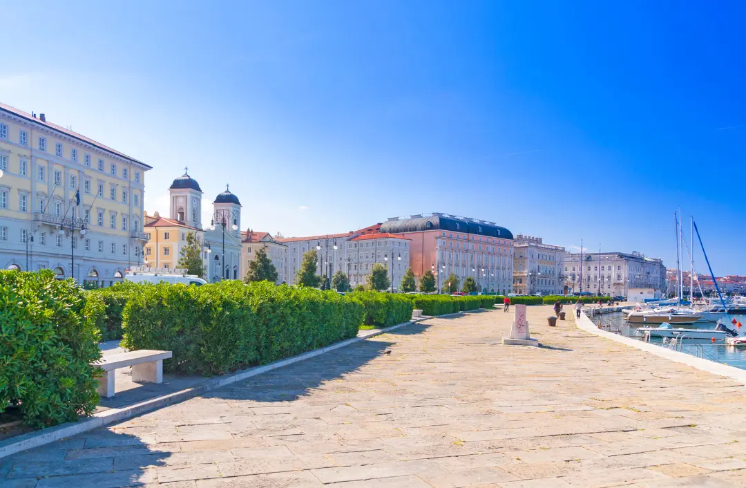Wide paved promenade lined with grand pastel buildings