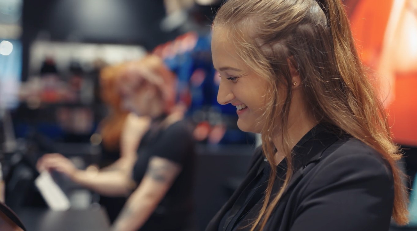 Customer service training - Thrive client Ann Summers retail employee working at till in store