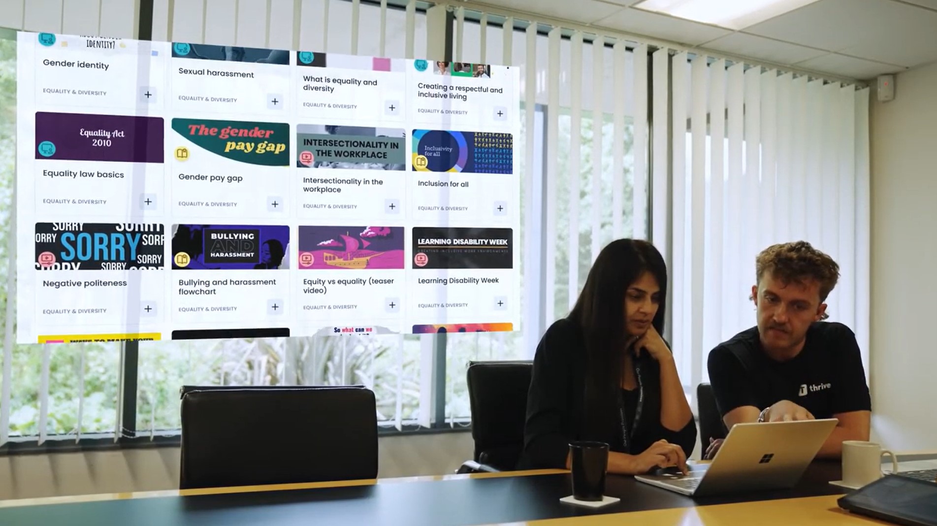 Places for People employees looking at wellbeing campaigns within Thrive LMS on laptop