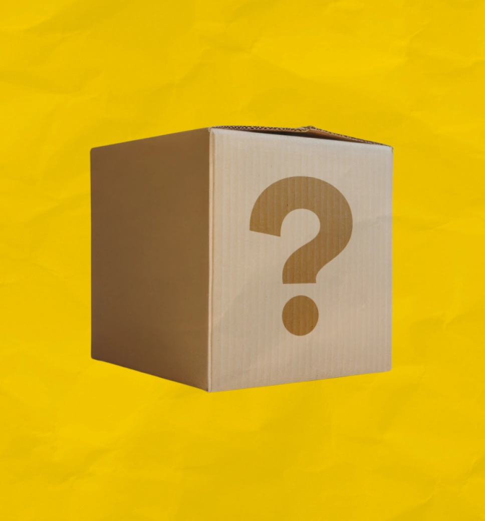 A cardboard box with a large question mark on its front, centered against a textured yellow background.