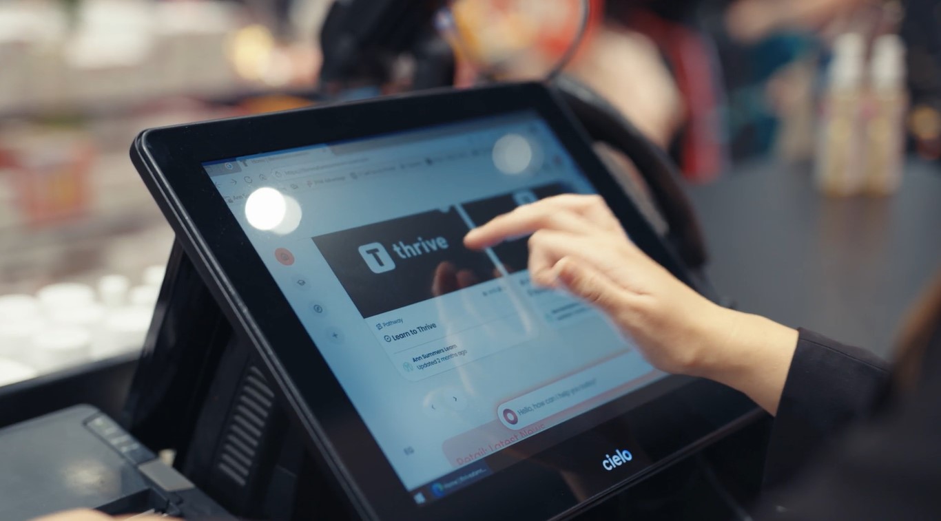 Retail employee accessing Thrive LMS via till system