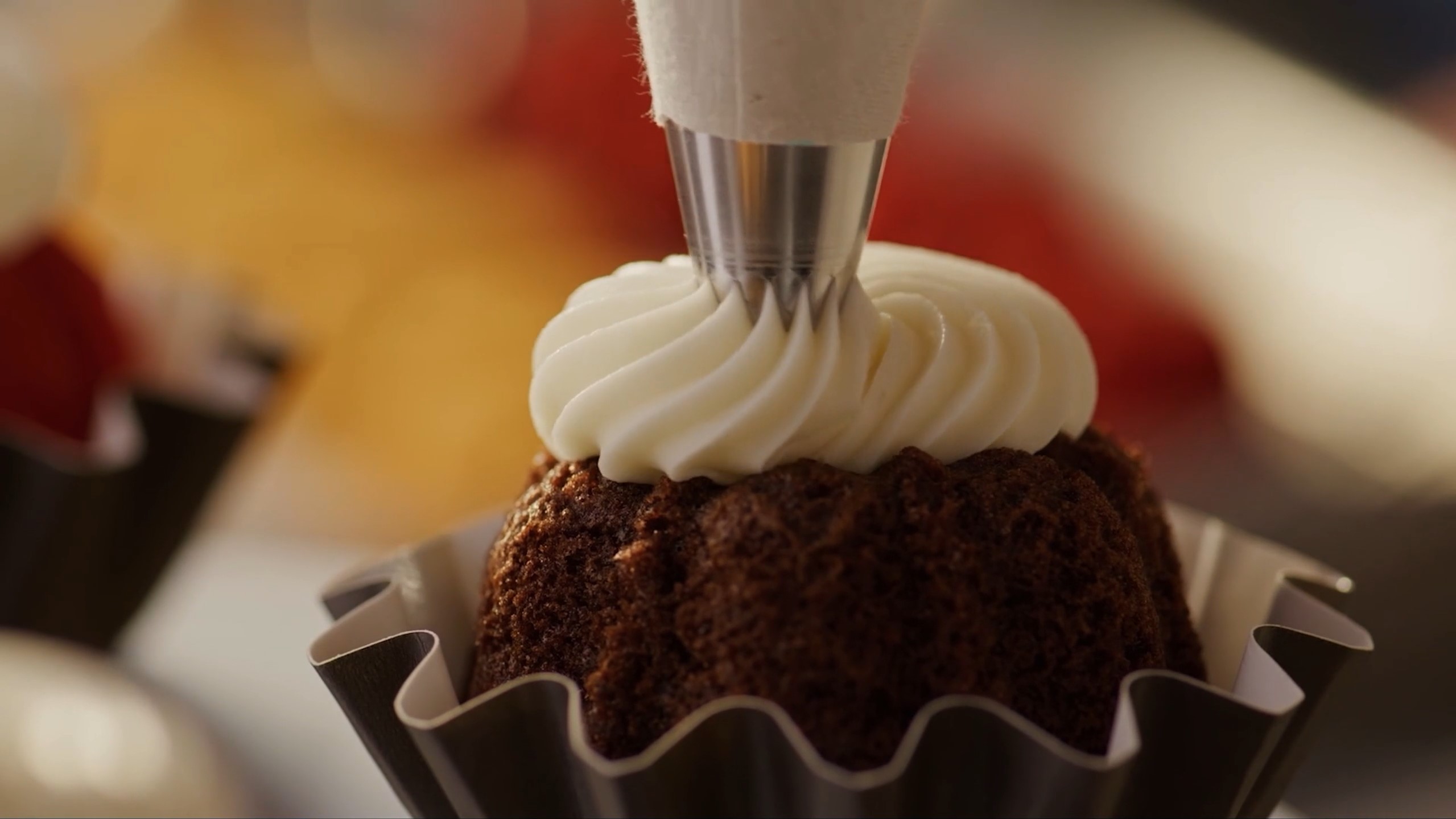 Nothing Bundt Cakes - Thrive retail customer - Decorating cake