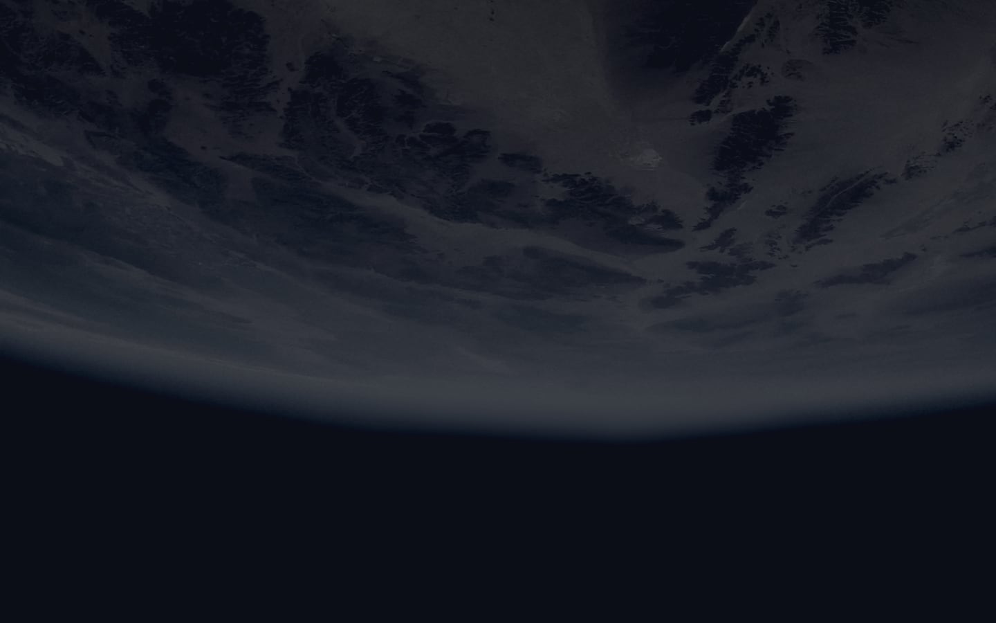 A cloudy planet with the black void of space below it.