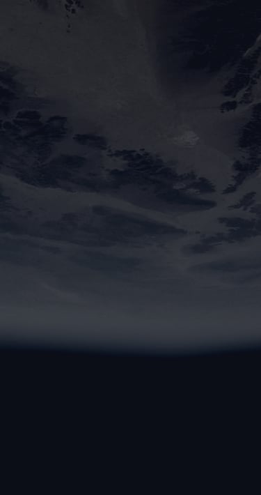 A cloudy planet with the black void of space below it.