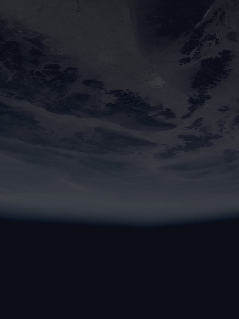 A cloudy planet with the black void of space below it.