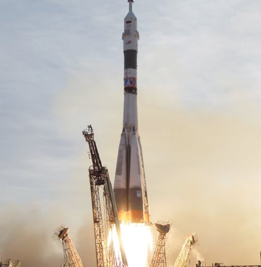 Spaceship lifting off from a launchpad.