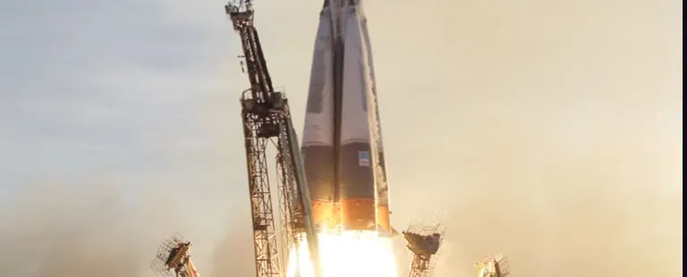Spaceship lifting off from a launchpad.