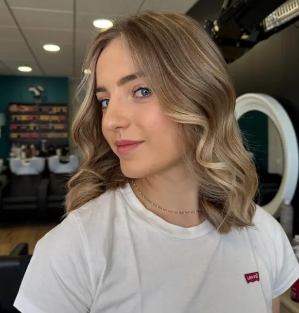 Femme de face avec un balayage blond sur cheveux mi-long