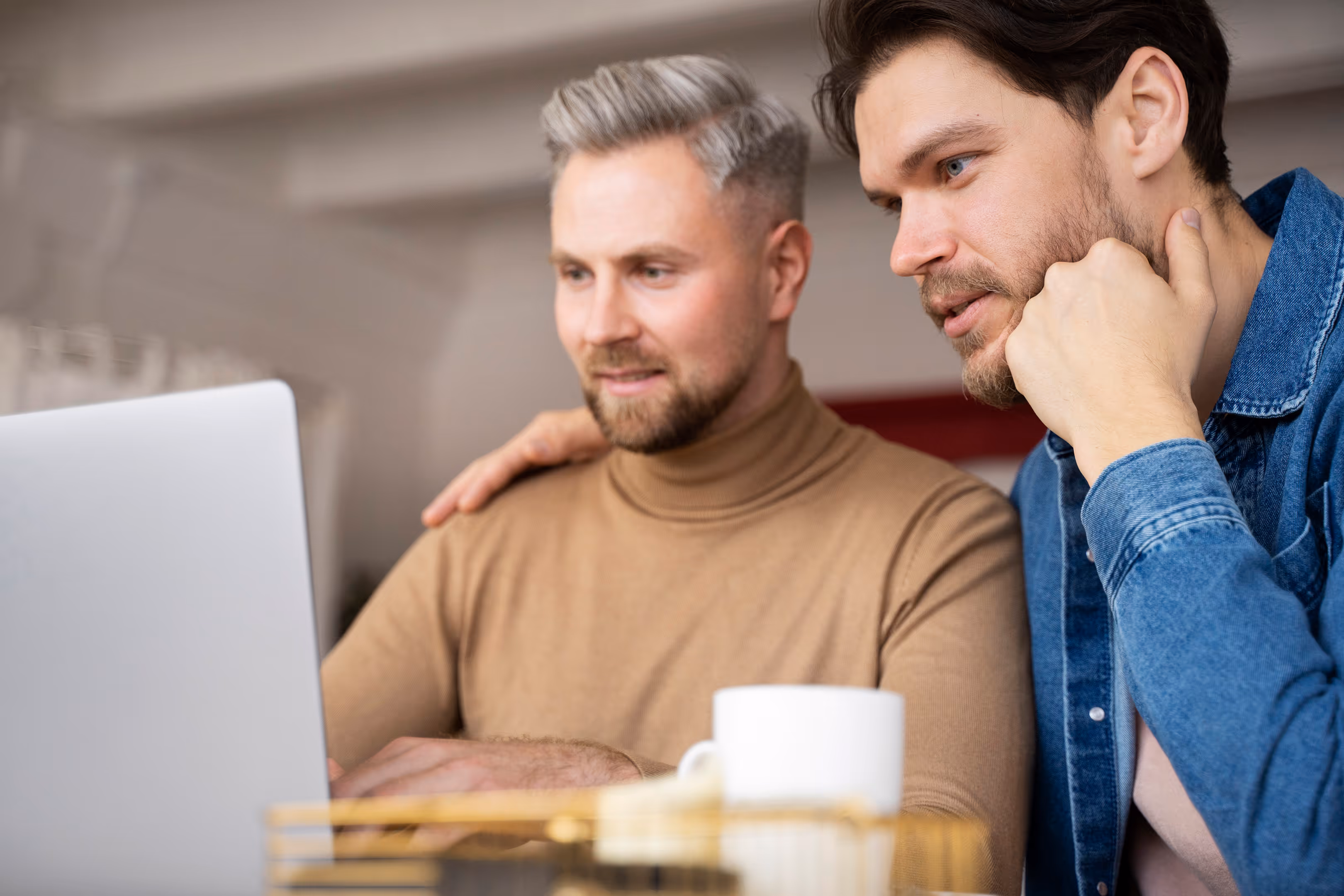 Close-up of two people looking at a laptop