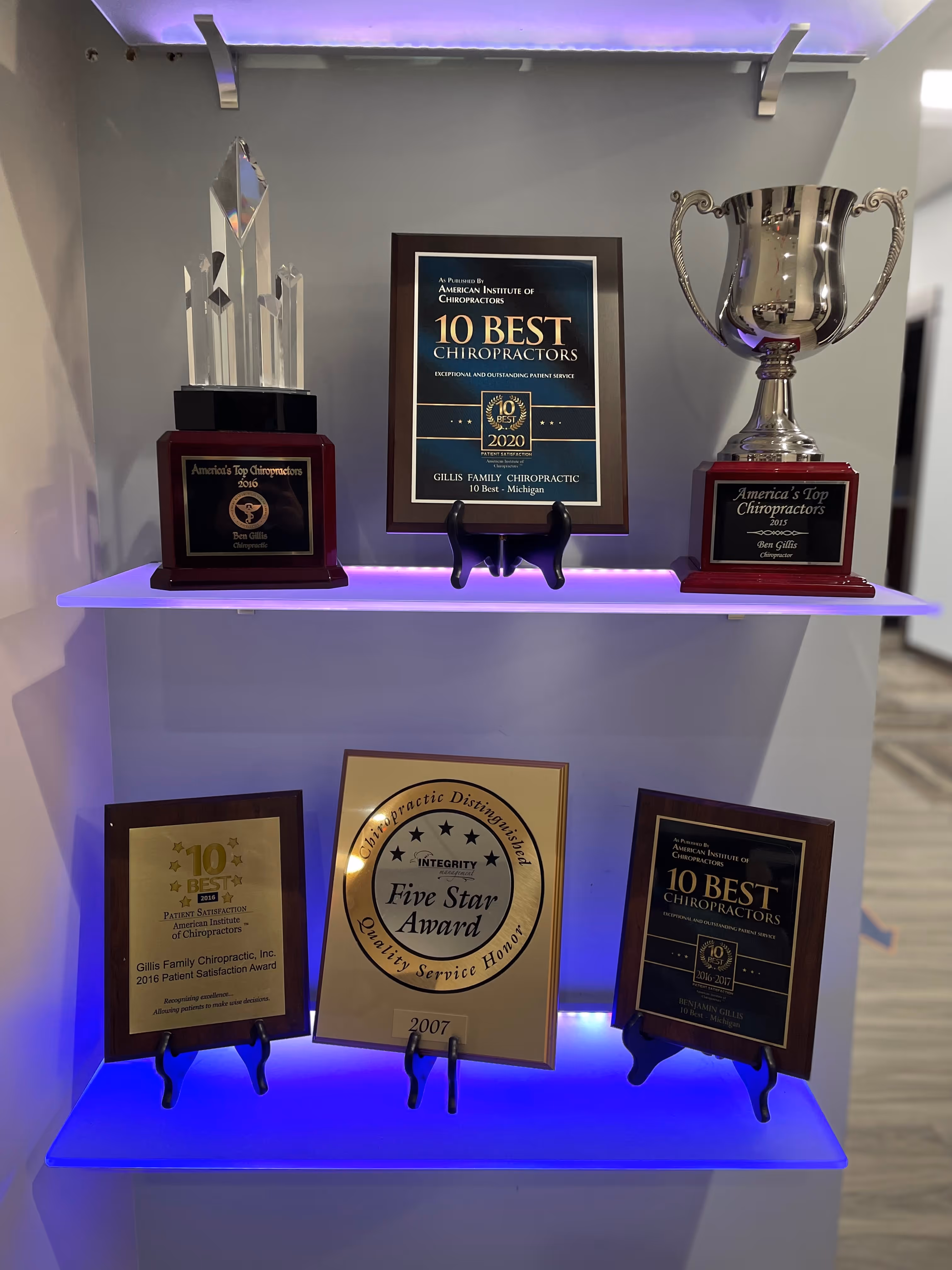 Awards display featuring Gillis Family Chiropractic’s honors, including Top 10 Chiropractors, Five Star Award, and patient satisfaction awards in Wyoming MI.
