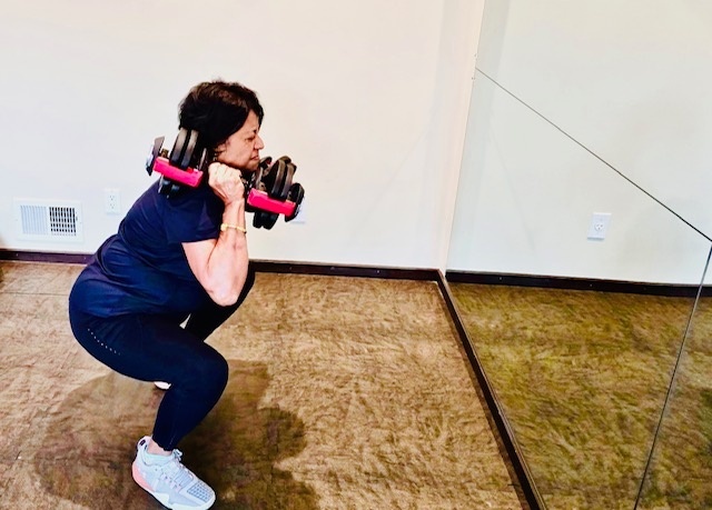 A woman over 50 lifting heavy weights.