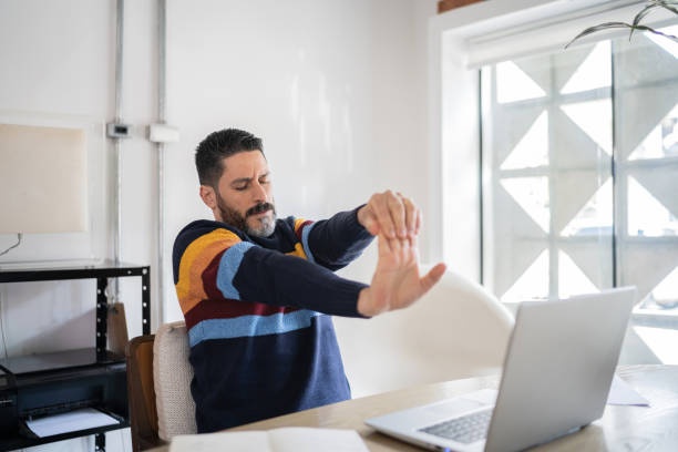 Man doing the wrist flexor exercise to relieve tightness and tension.