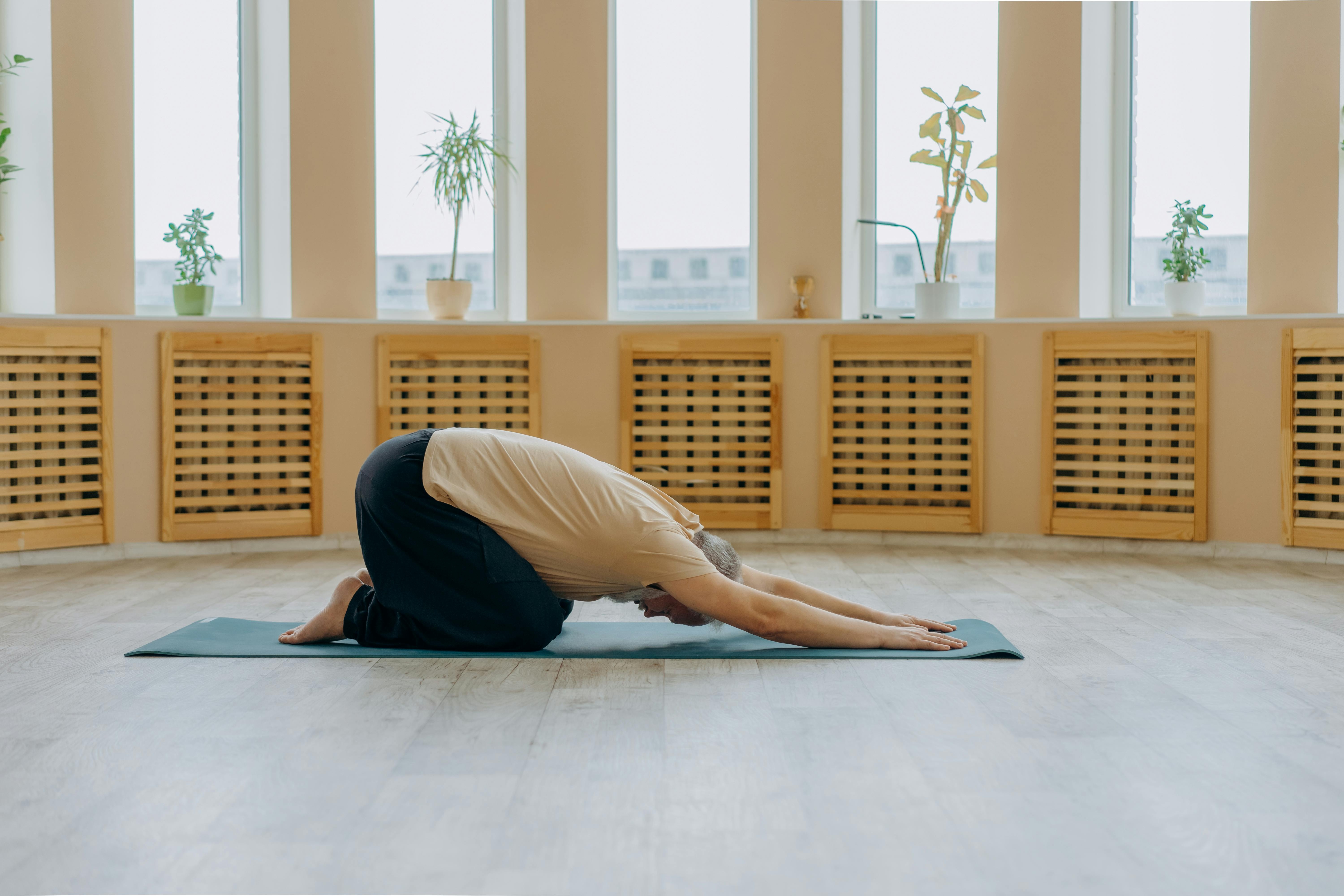 A woman in the child's pose as a gentle shoulder pain exercise.