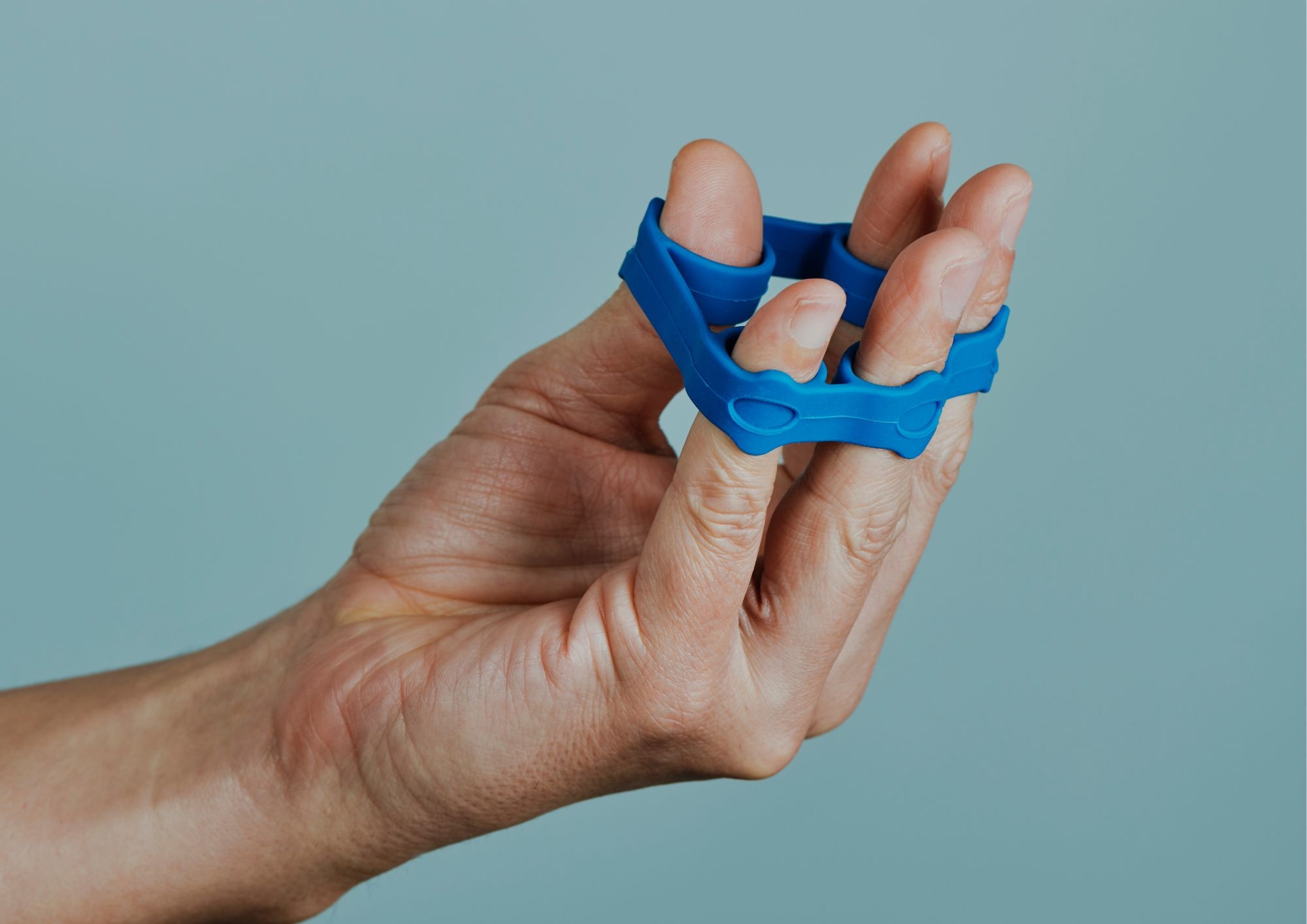 Person building resilience in the fingers with a great exercise for trigger finger that manages pain.