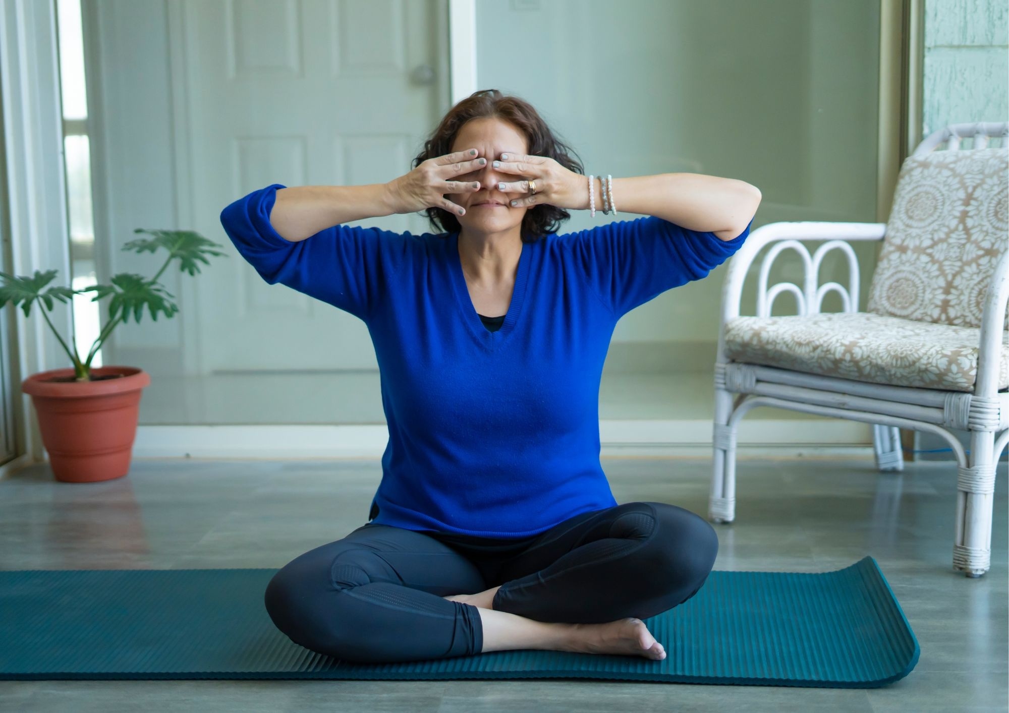 A woman doing eye yoga with MyYogaTeacher's 1-on-1 coaching.