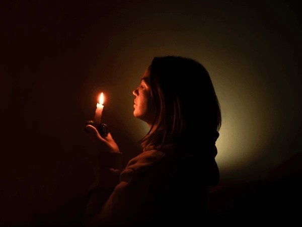 A woman doing the candle gazing eye yoga.