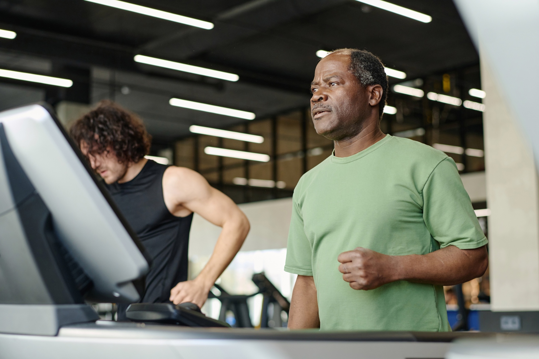 Older man feeling lost and unable to navigate gym equipment.