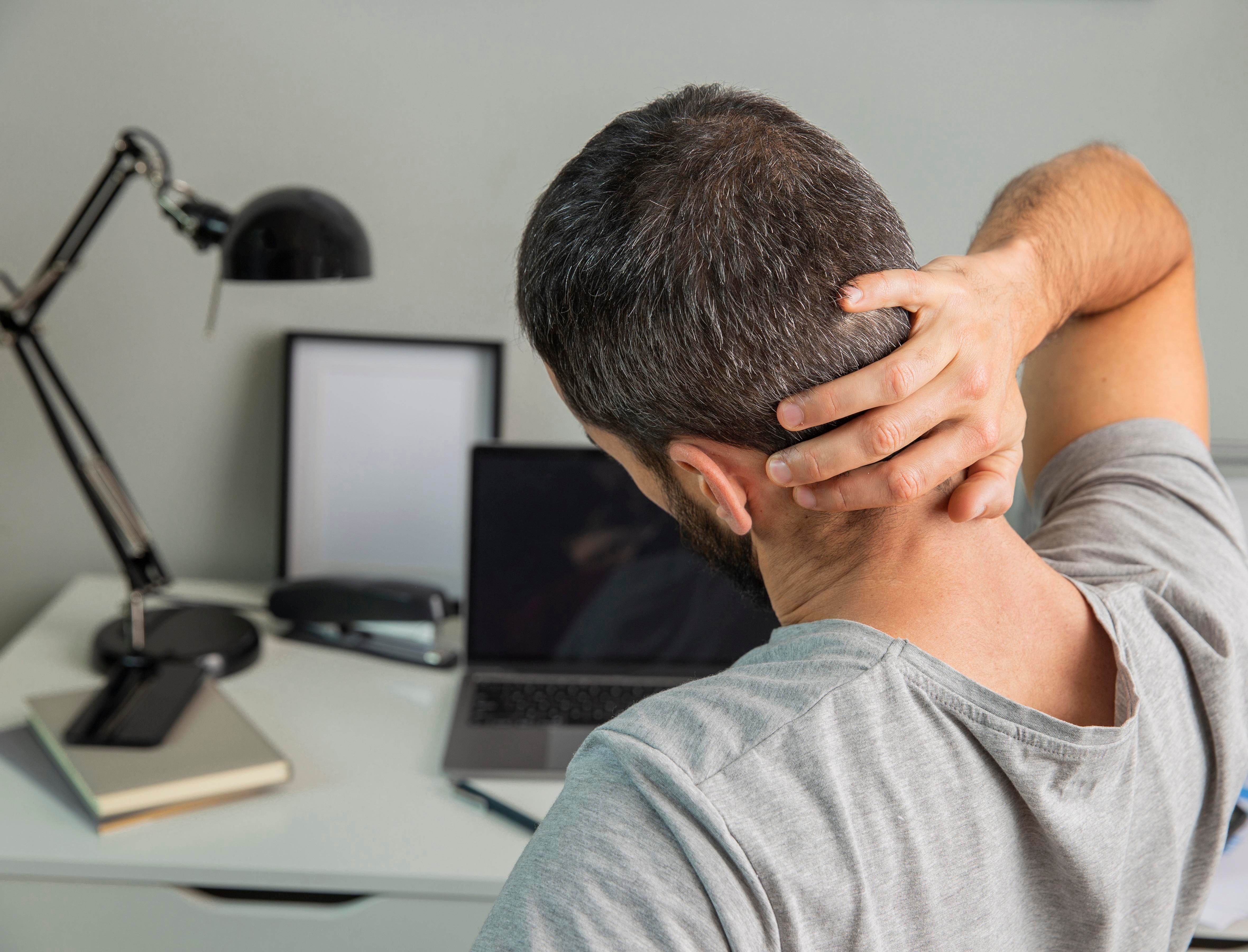 40 year old man feeling stiff after prolonged sitting for work.