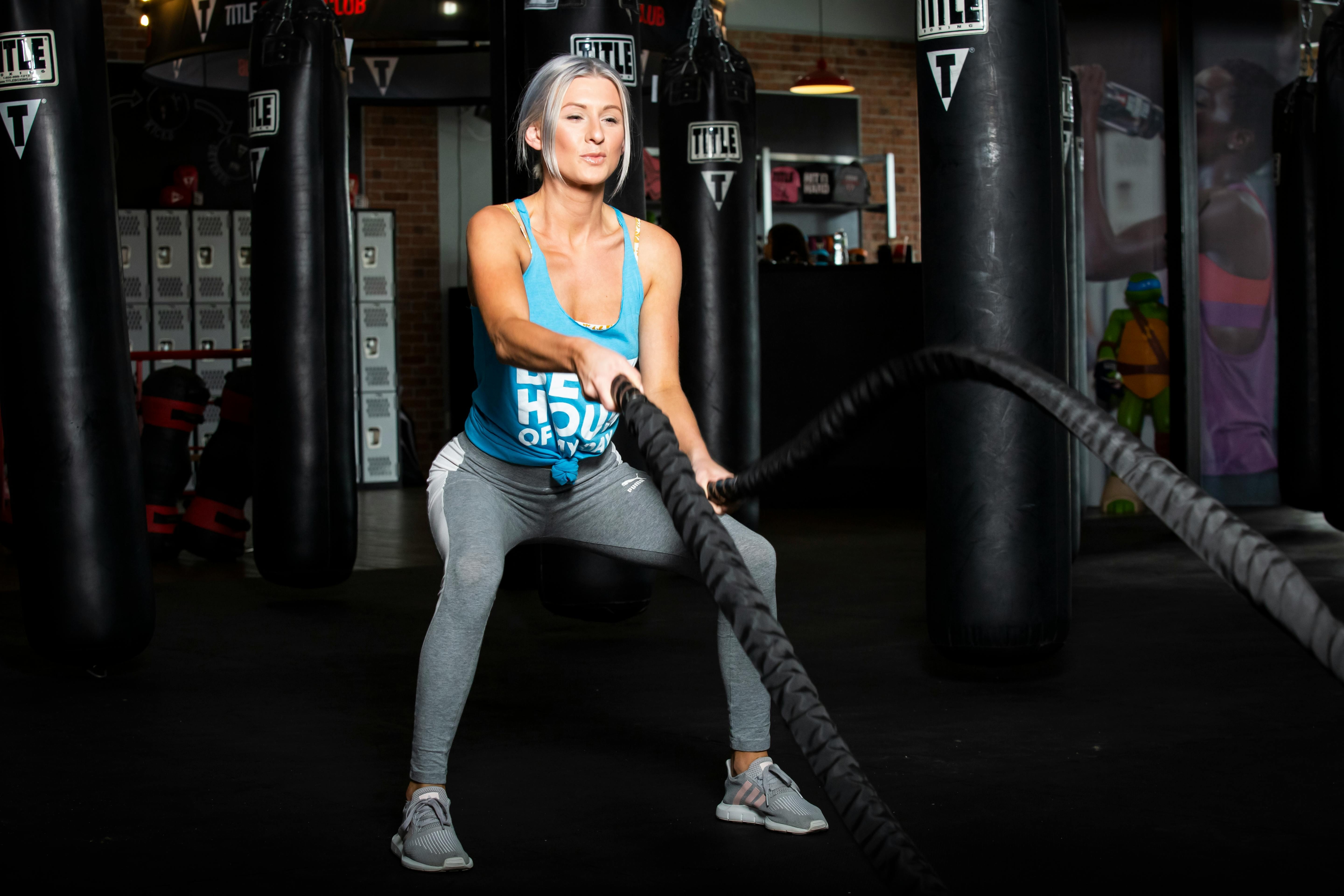A woman using gym equipment for her workout.