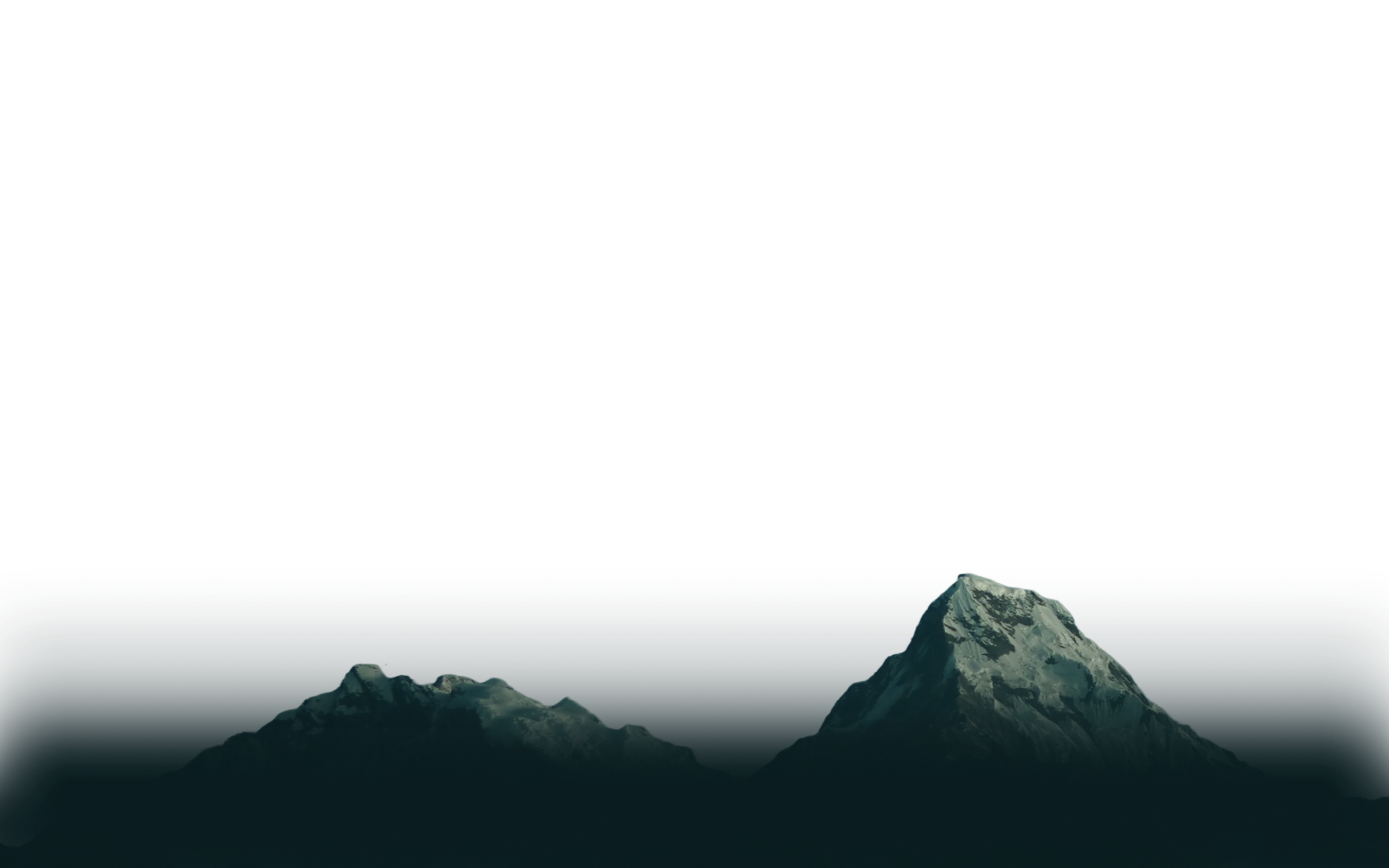 Snow-covered mountain peaks under a dark sky.