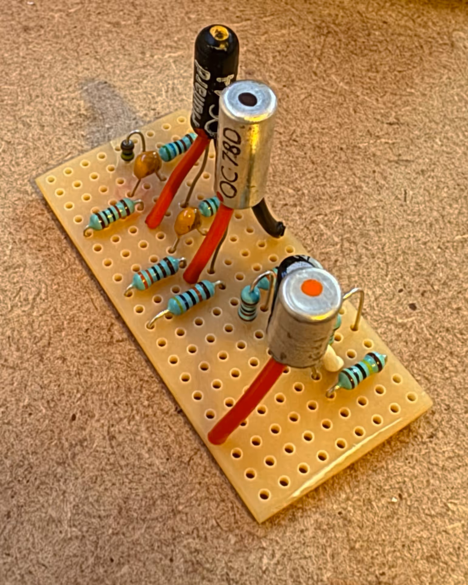 a small circuit board with three original Mullard transistors, resistors and capacitors.