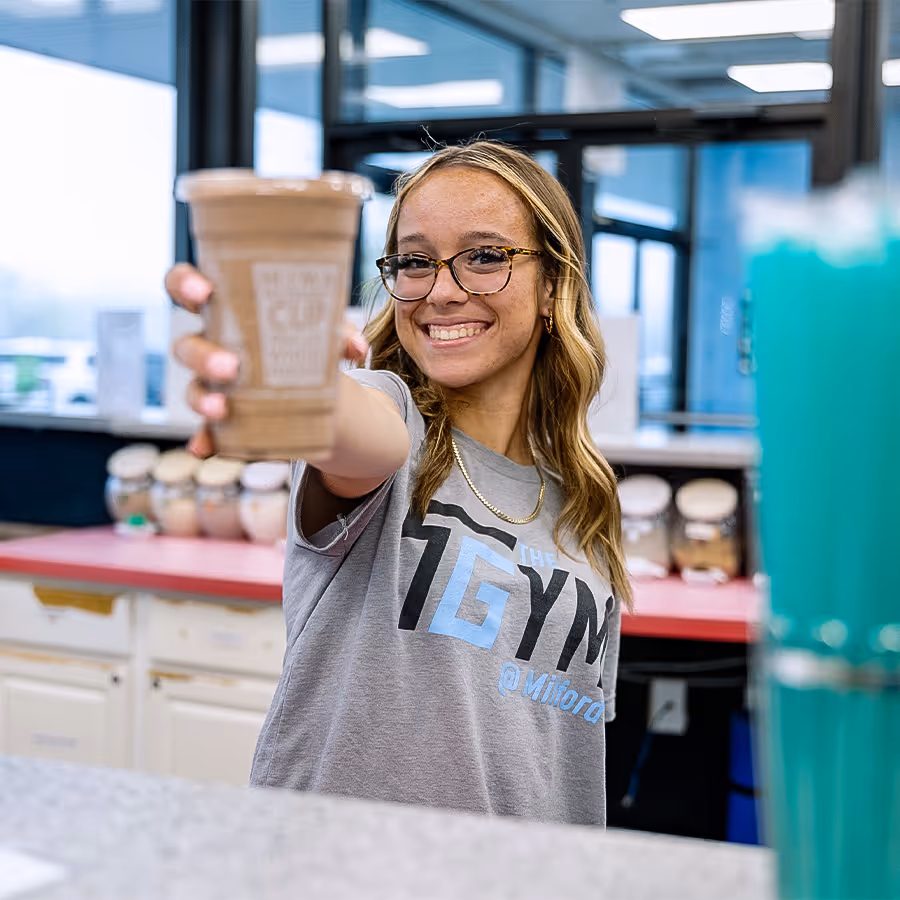 Staff member handing you a shake from the shake bar