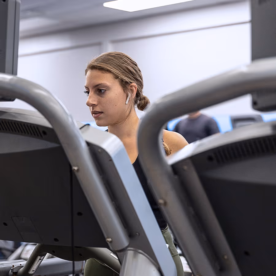 Gym member walking on treadmill during their cardio workout.