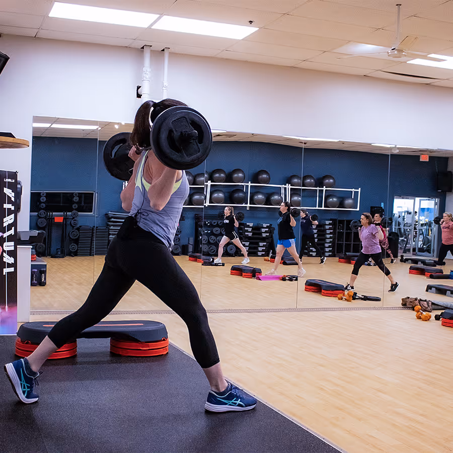 Group fitness instructor leading strength class