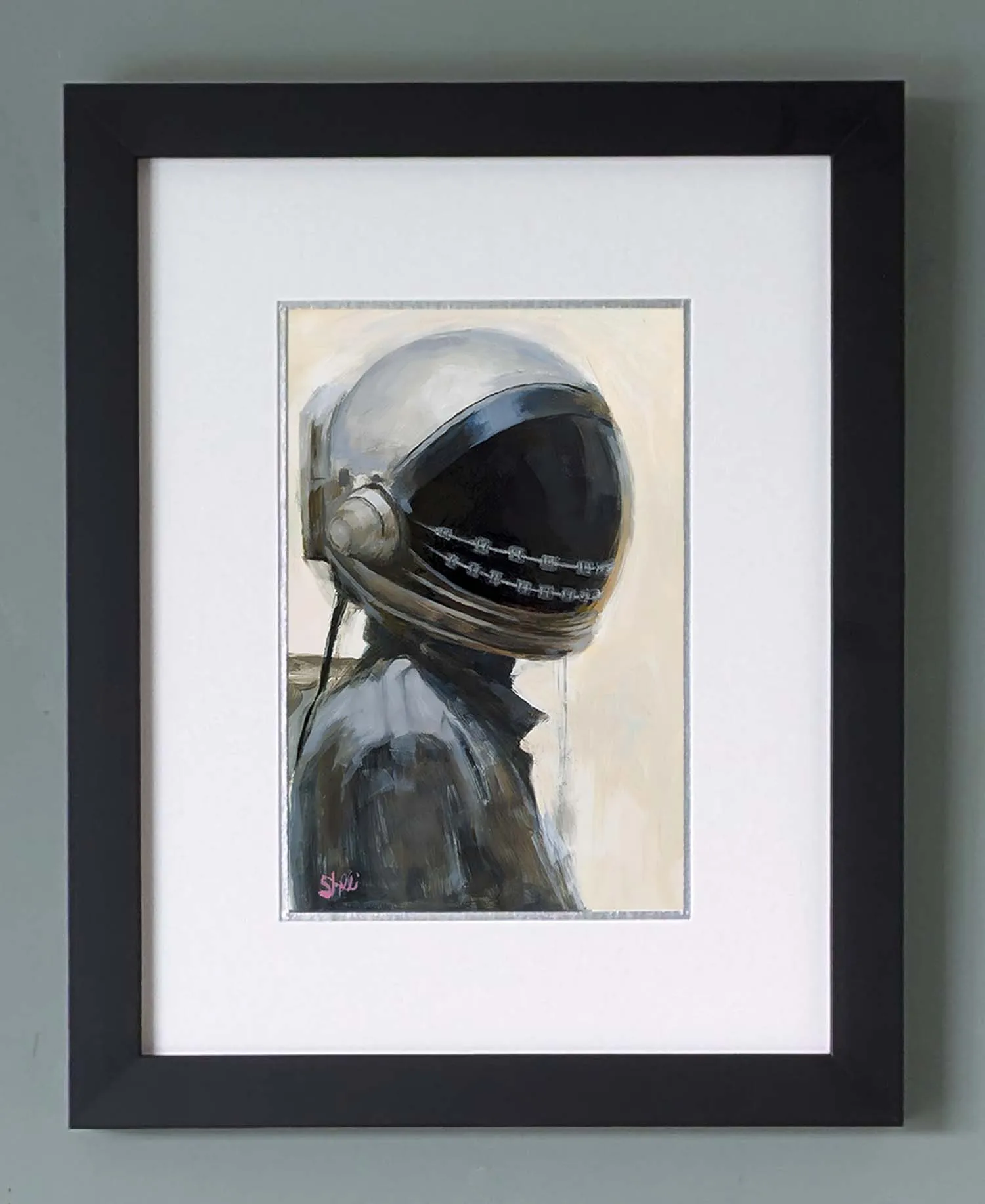 framed portrait of female astronaut looking Eastward wearing black and a dark visor with embedded braces