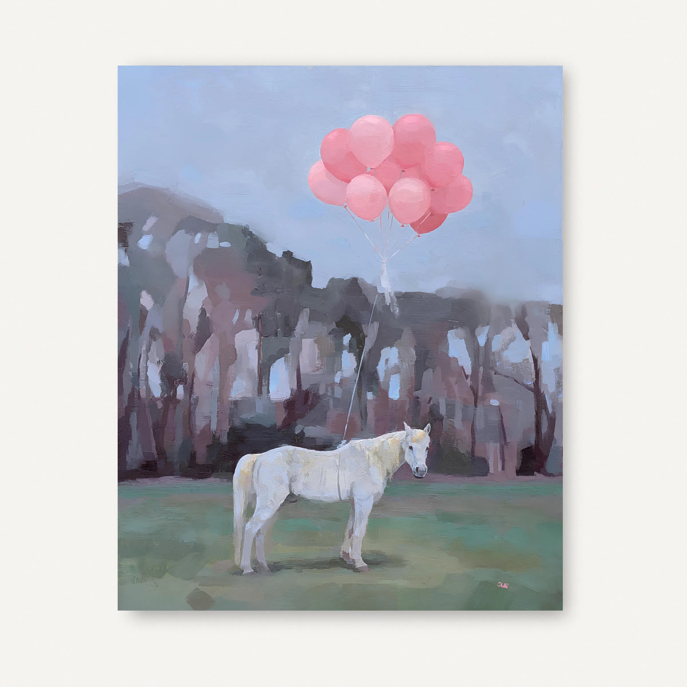 grey-white horse tethered to a bundle of pink balloons standing in a green pasture with treeline in background