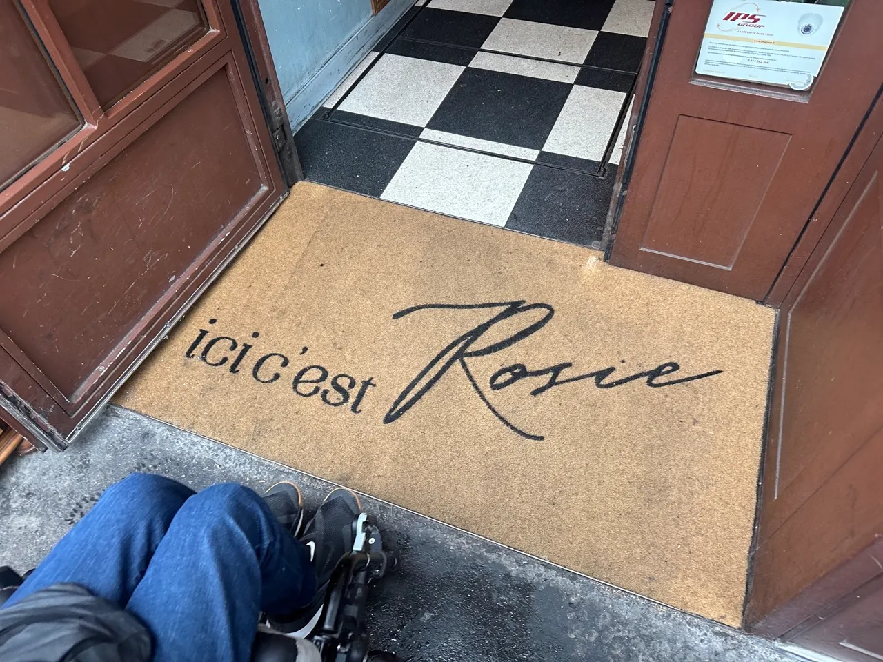 Entrance to Brasserie Rosie with wide manual door
