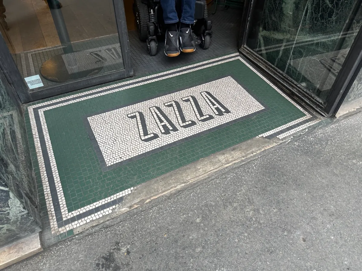 Entrance to Zazza showing tiled ramp with slight lip to pavement.