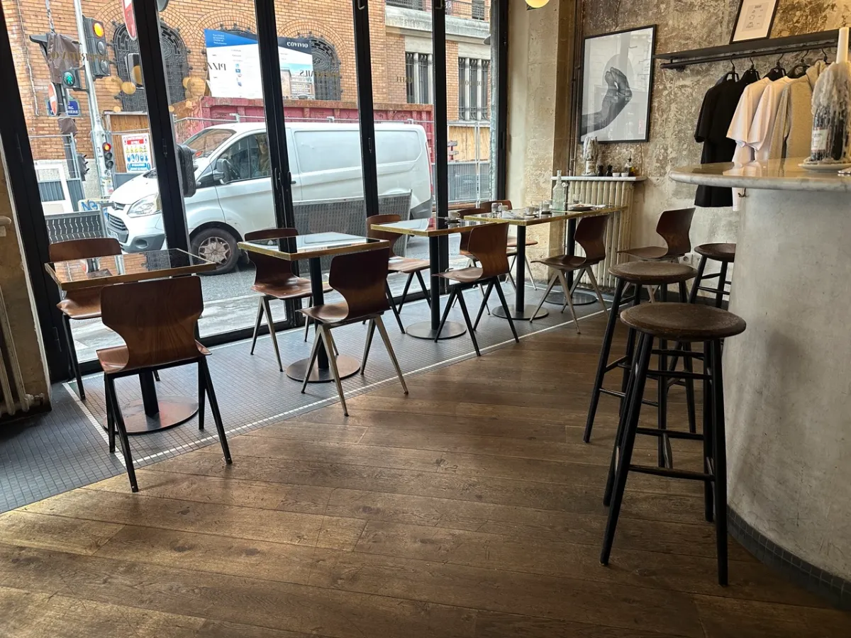 Spacious dining room at Zazza with plenty of room between tables and windows to street.