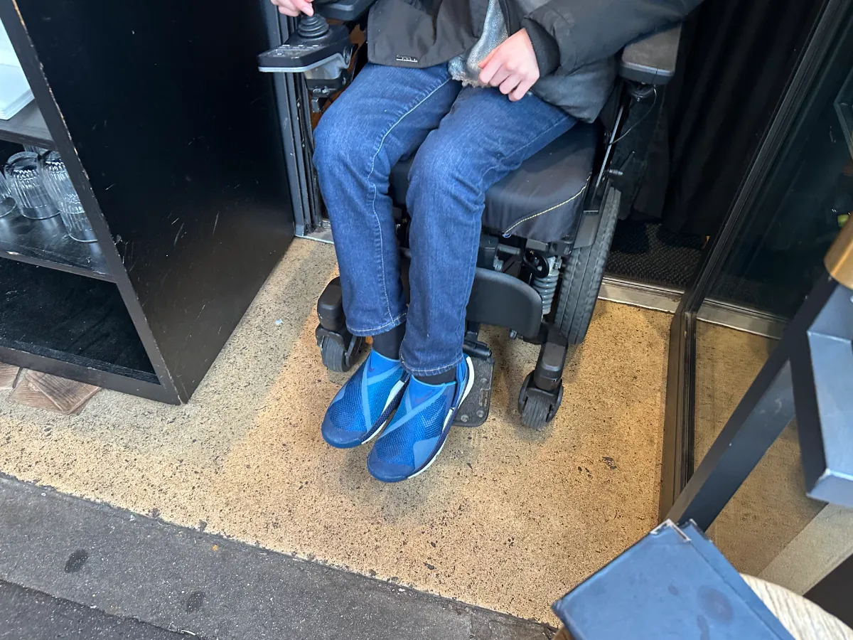 Wide step-free entrance of Breizh Café Odéon with wheelchair exiting