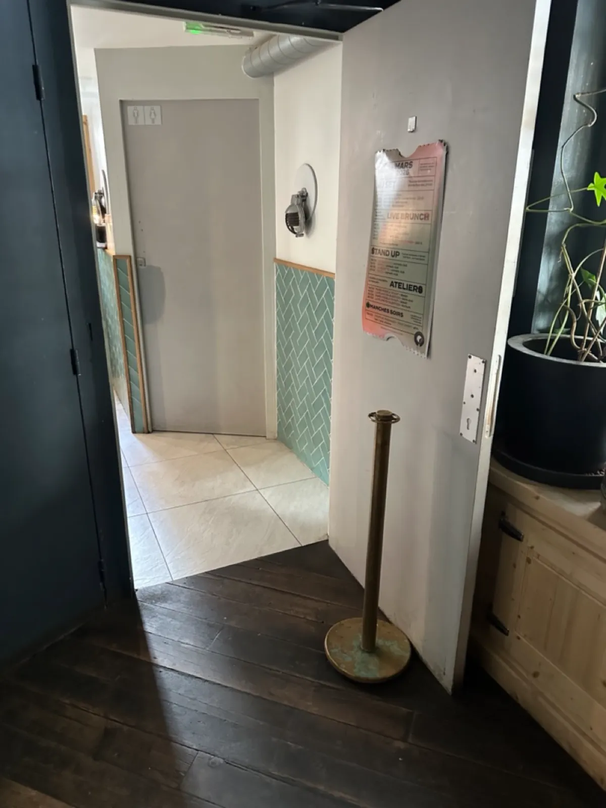 Entrance to the bathroom at Poinçon - wide door propped open