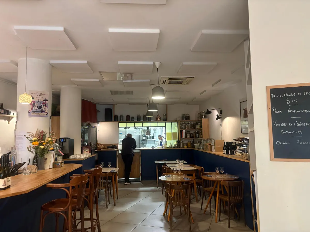 Spacious dining room of Trois B with kitchen at the rear