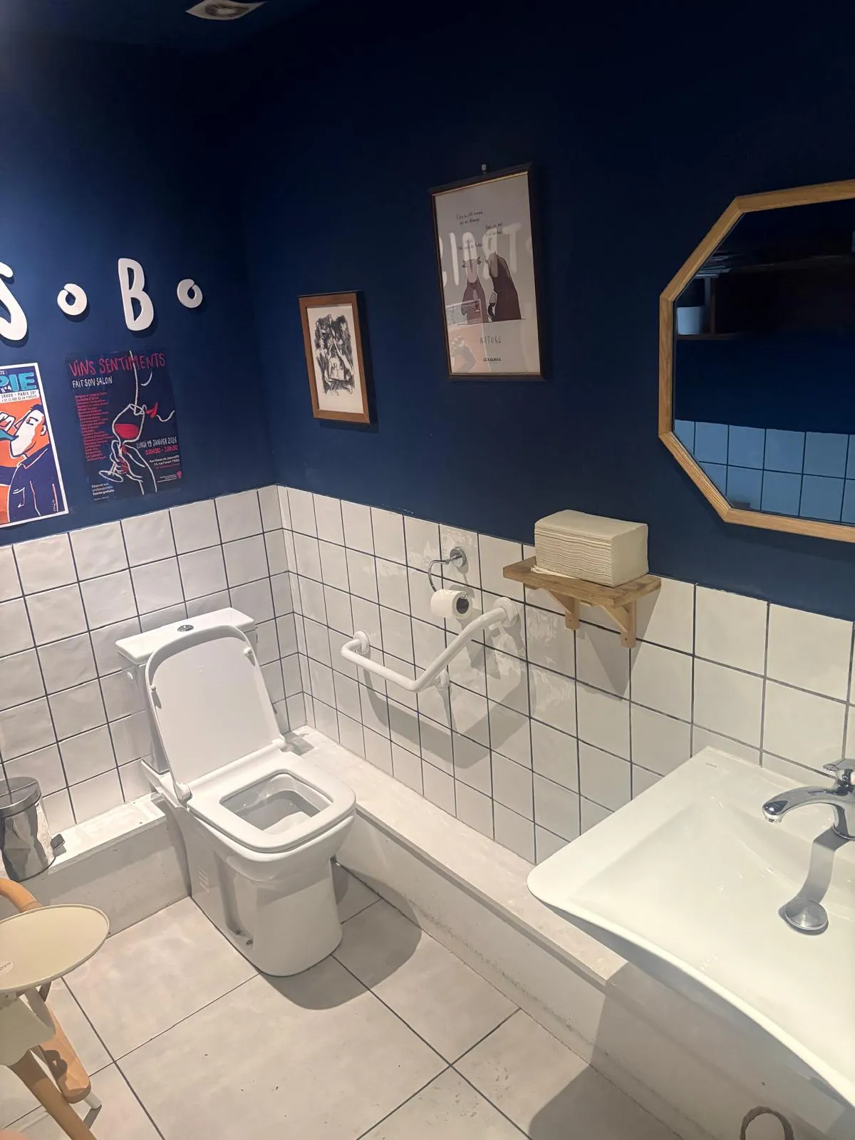 Accessible toilet at Trois B with a baby high chair 