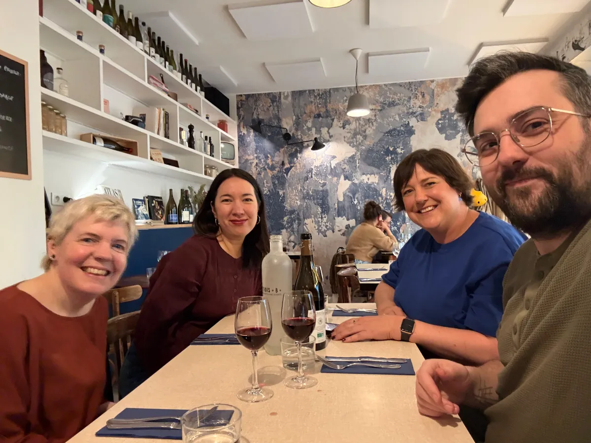Table of happy customers in main dining room at Trois B
