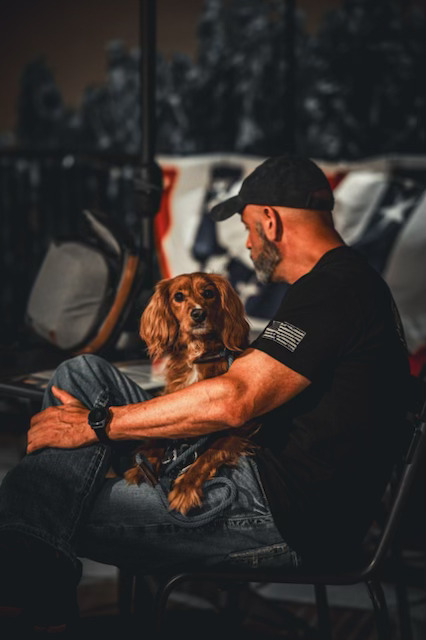 Jeff sitting down with puppy