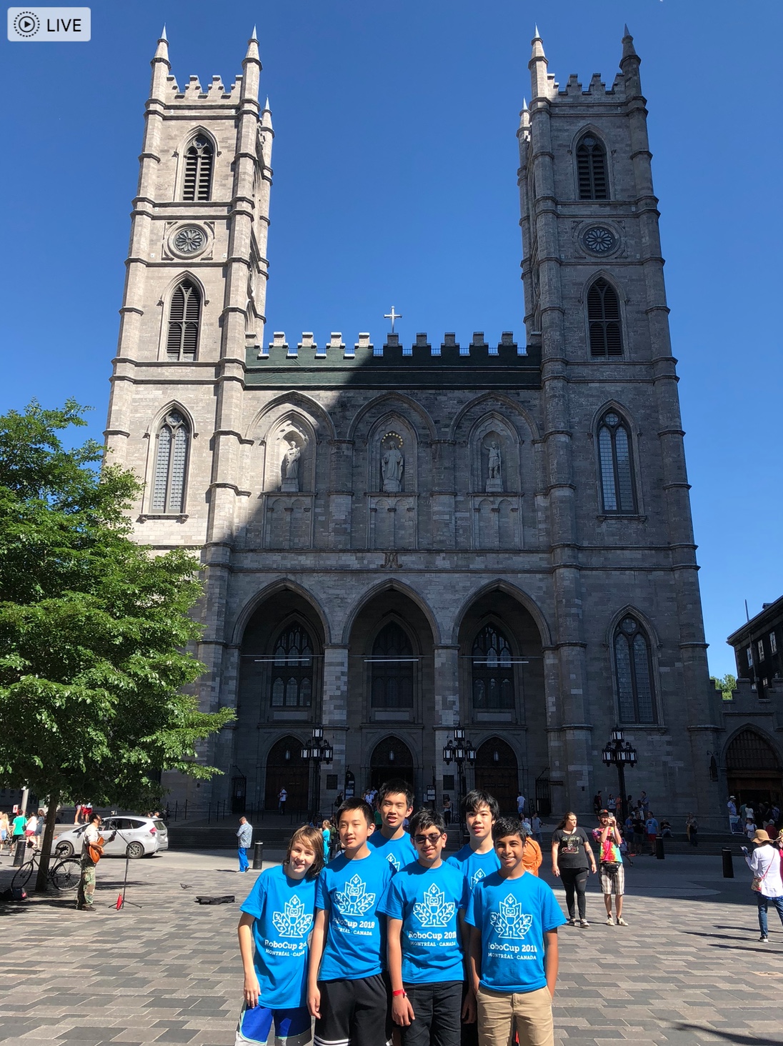 Team in blue shirts in front of Notre-Dame Basilica in Montreal