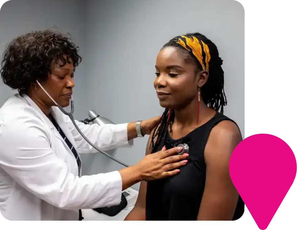 Doctor listening to patient's heartbeat with stethoscope in office