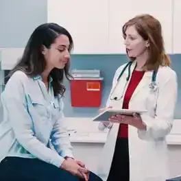 Patient reviewing notes with doctor in doctors office