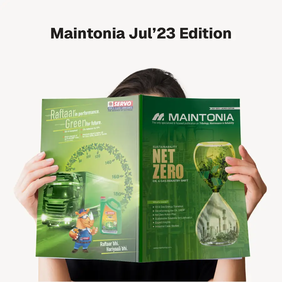 Person holding the July 2023 edition of Maintonia magazine featuring sustainability and net zero in oil and gas industry with a green-themed cover showing an hourglass with industrial imagery and a truck advertisement.