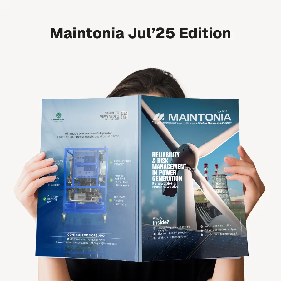 Person holding the Maintonia Jul'25 Edition magazine featuring a wind turbine and power plant on the cover.